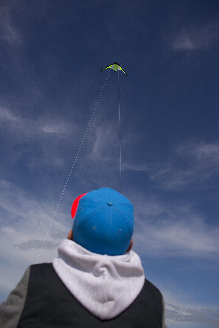 Boy on the beach at the Baltic Sea flying a kite, Western Pomerania Lagoon Area National Park, Dierhagen, Fischland-Darss-Zingst, Mecklenburg-Western Pomerania, Germany