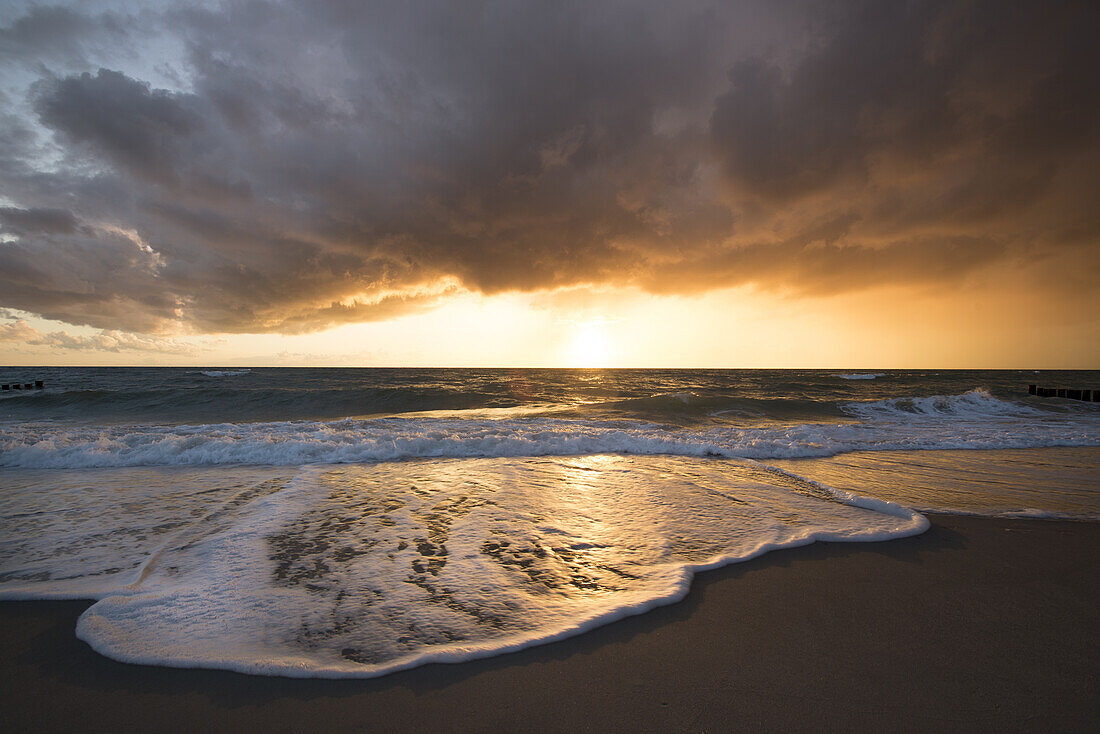 Sunset with storm clouds on the Baltic Sea in the Western Pomerania Lagoon Area National Park, Dierhagen, Fischland-Darss-Zingst, Mecklenburg-Western Pomerania, Germany