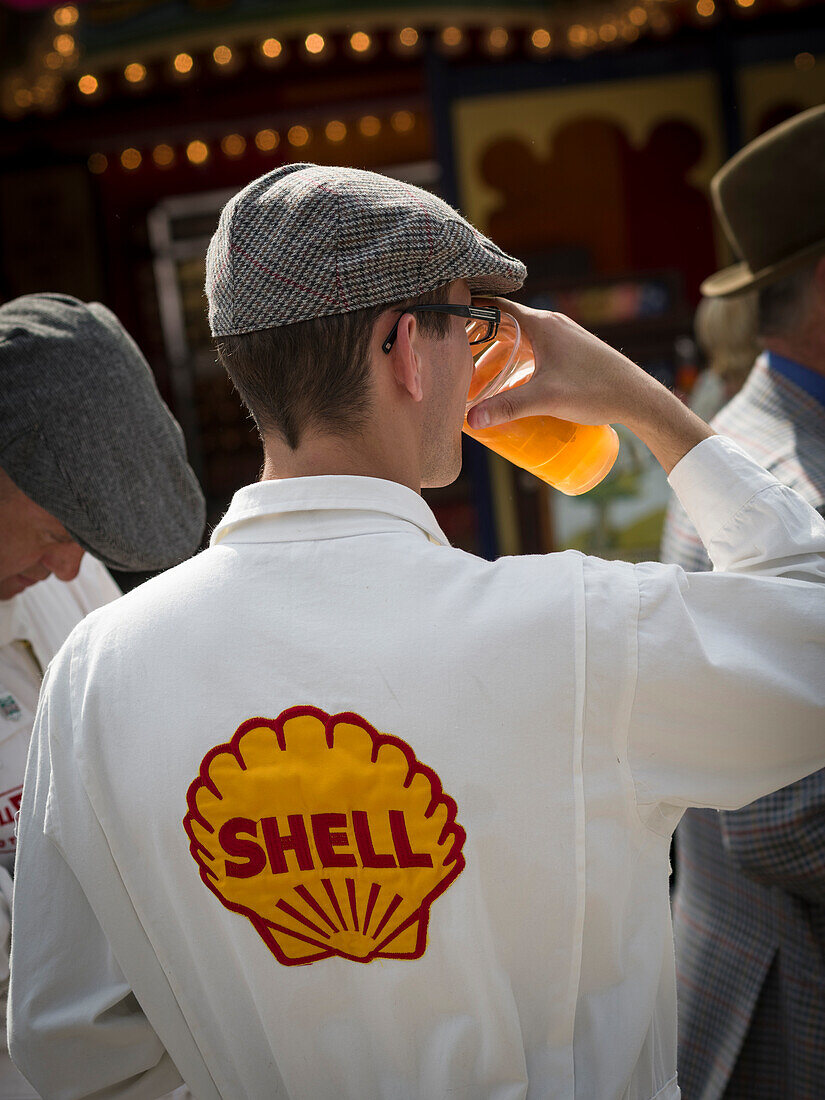 Visitor drinking, Goodwood Revival 2014, Racing Sport, Classic Car, Goodwood, Chichester, Sussex, England, Great Britain