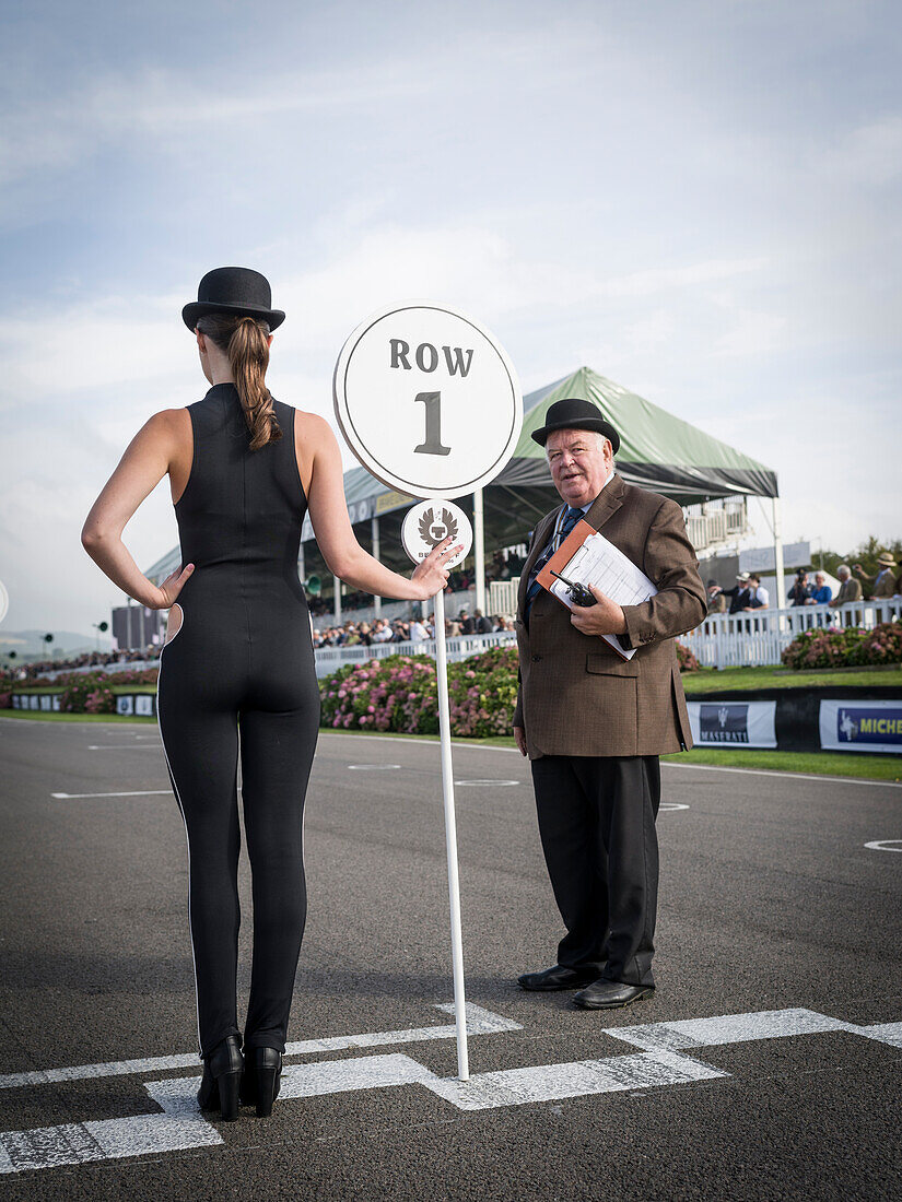 Gridgirl and course clerk, Goodwood Revival 2014, Racing Sport, Classic Car, Goodwood, Chichester, Sussex, England, Great Britain