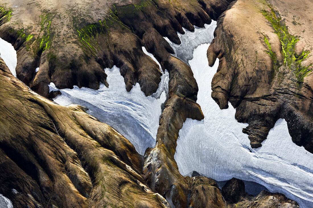 Aerial snow fields in colorful rhyolith mountains, geothermal area of Landmannalaugar, Laugarvegur, Highlands, South Iceland, Iceland, Europe