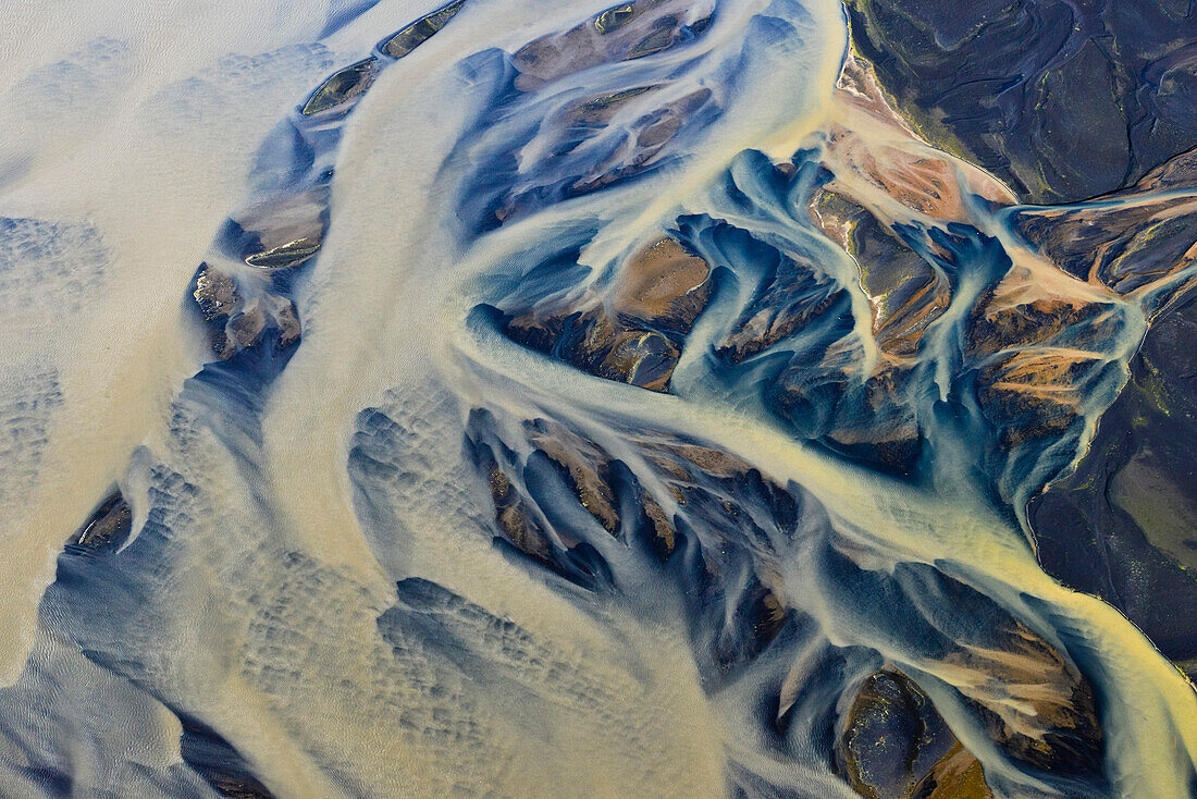 Aerial view of colorful meanders of  glacial river Thjorsa floating over the lava area (sander) Landeyarsandur, South Iceland, Iceland, Europe
