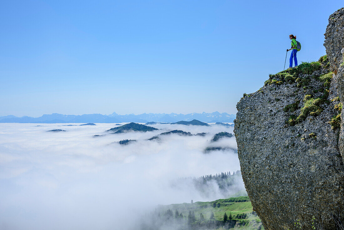 Woman hiking standing on  molasse conglomerate, fog in the valley, Hochgrat, Nagelfluh range, Allgaeu Alps, Allgaeu, Svabia, Bavaria, Germany