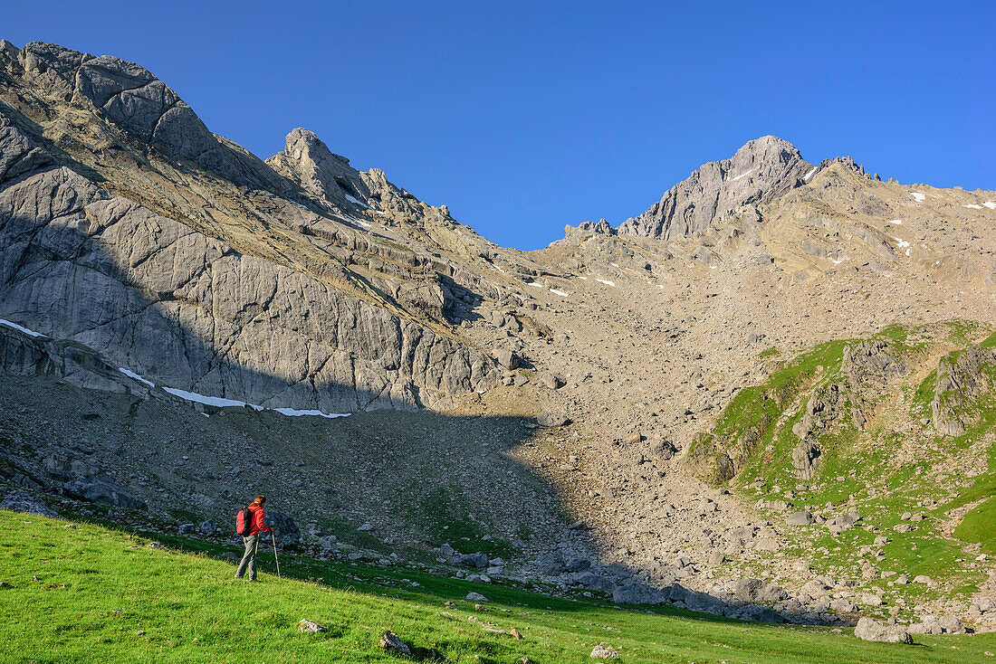 Woman hiking ascending on meadow, valley Fundaistal, Lechtal Alps, Tyrol, Austria