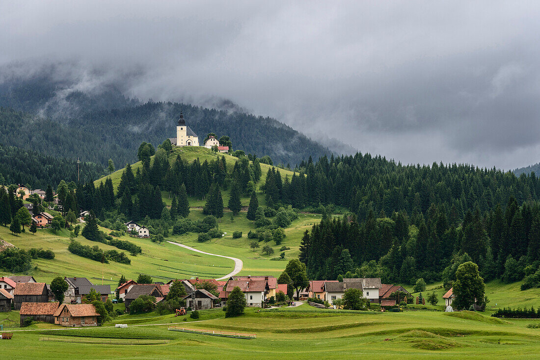 Village at base of rolling landscape, Retje, Notranjska, Slovenia, Retje, Notranjska, Slovenia