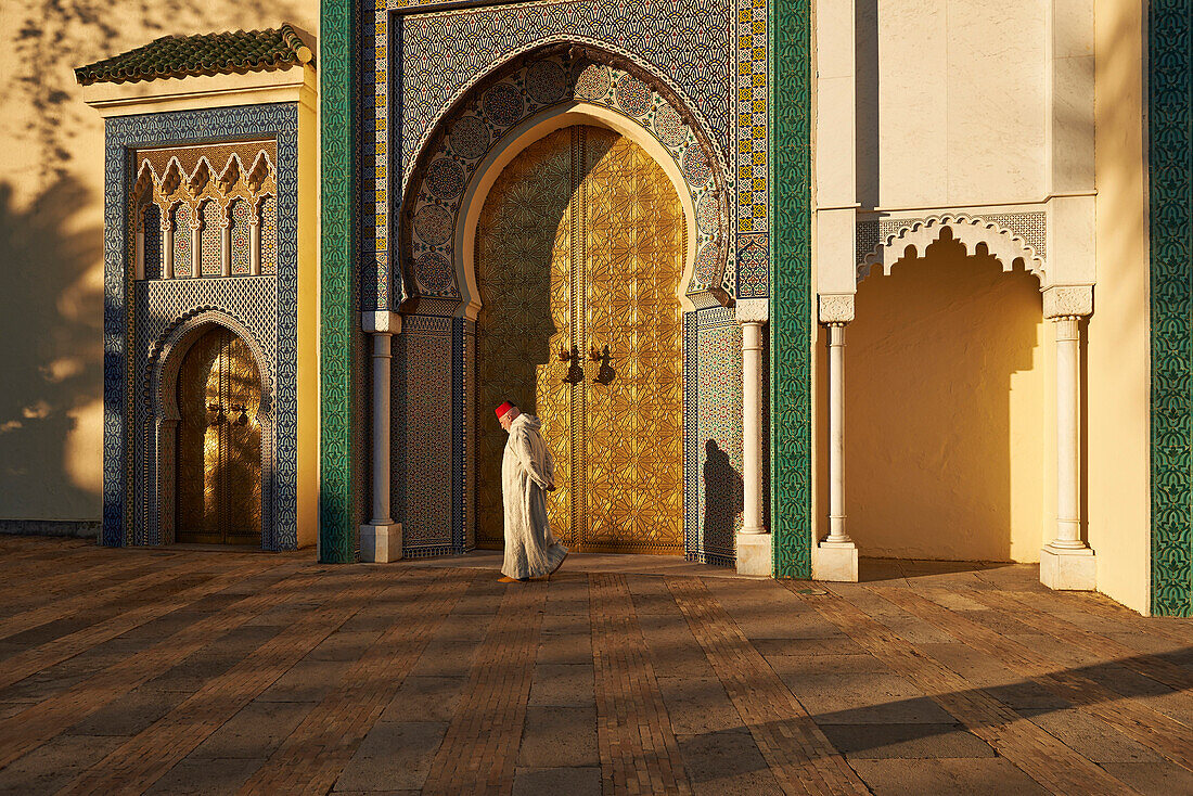 Caucasian man walking by ornate temple, Fes, Fes-Boulemane, Morocco