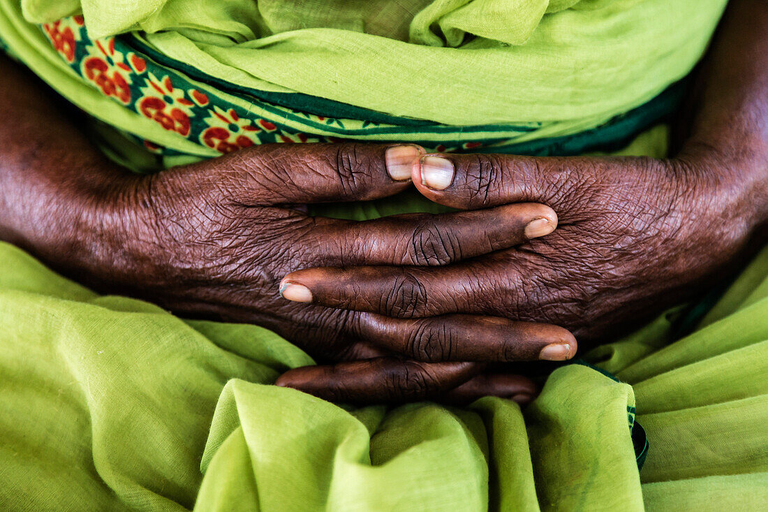Close up of market seller's folded hands, Madurai, Tamil Nadu, India