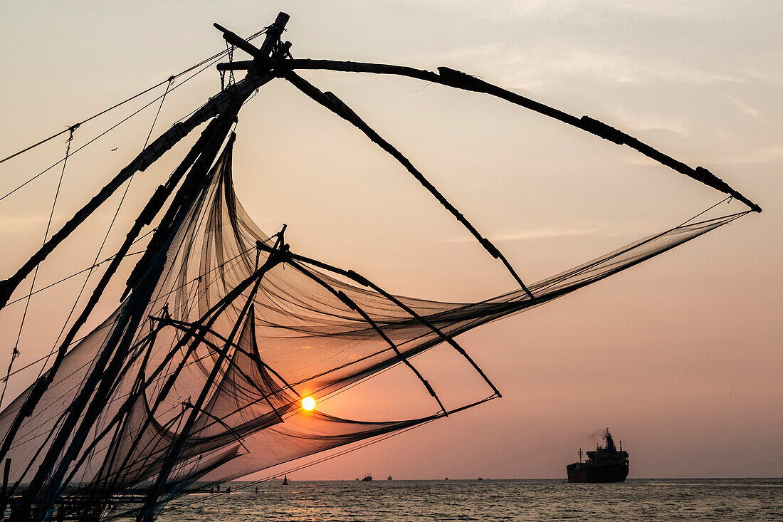 Silhouette of fishing nets at sunset, Fort Kochi, Kerala, India
