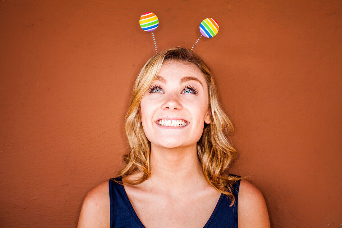 Caucasian teenage girl wearing novelty antenna, Folsom, California, United States