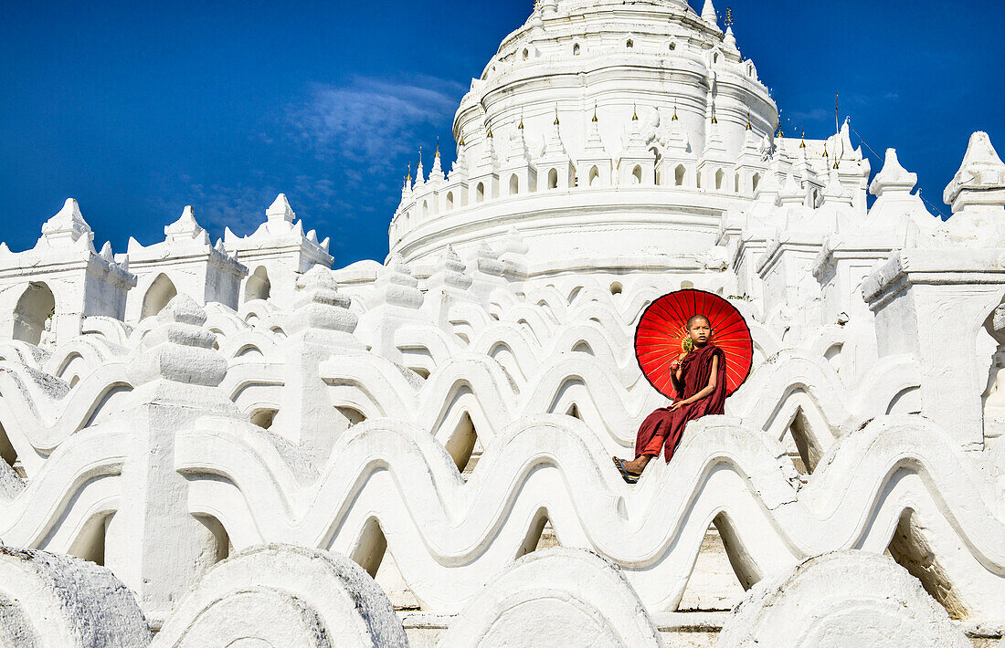 Asian woman sitting on temple walls, Mingun, Saigang, Myanmar, Mingun, Saigang, Myanmar