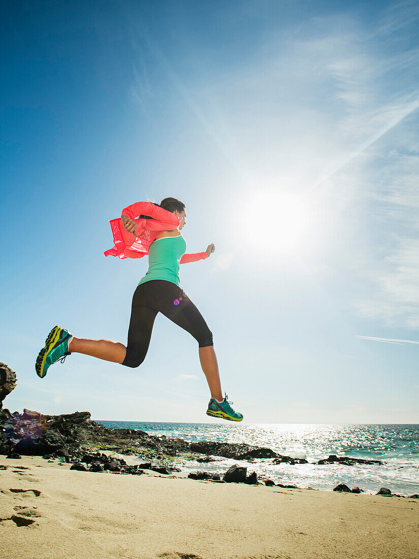 Caucasian woman running on beach, Laguna Beach, California, USA