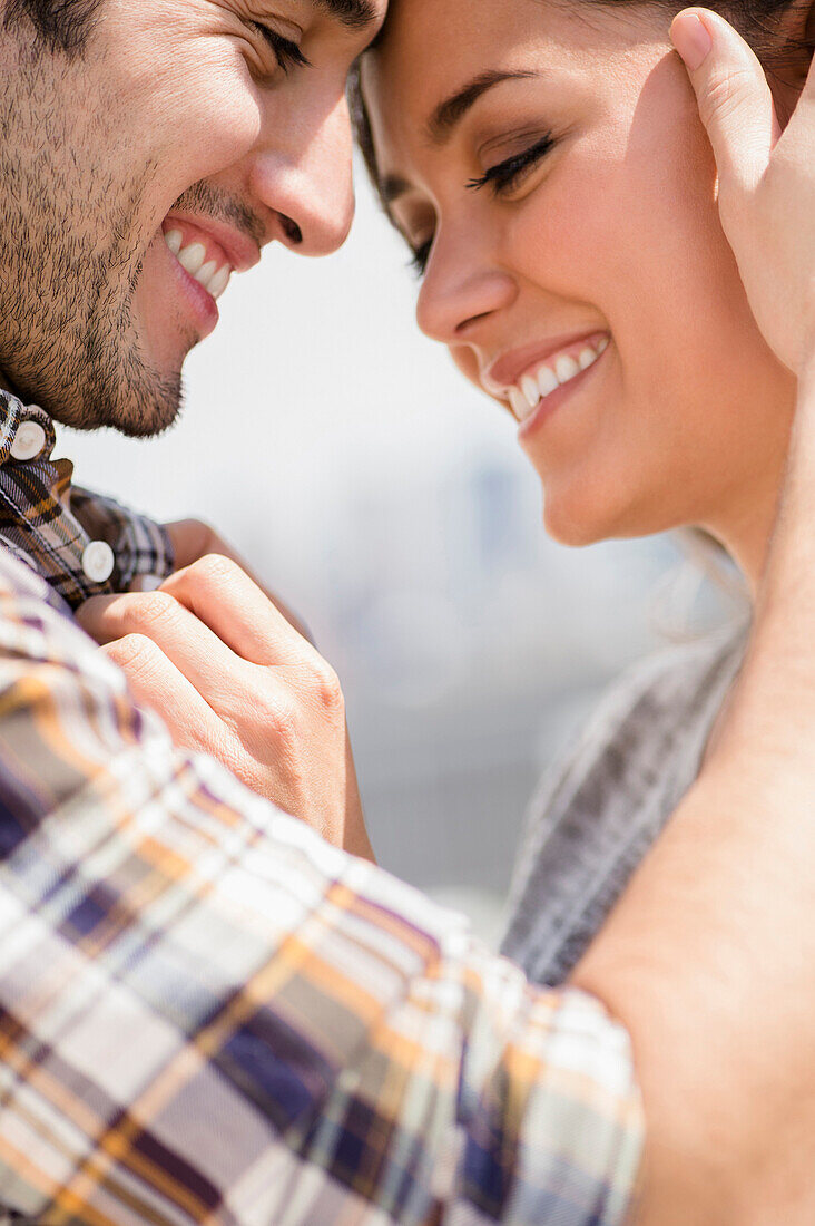 Smiling couple hugging, Jersey City, New Jersey, USA