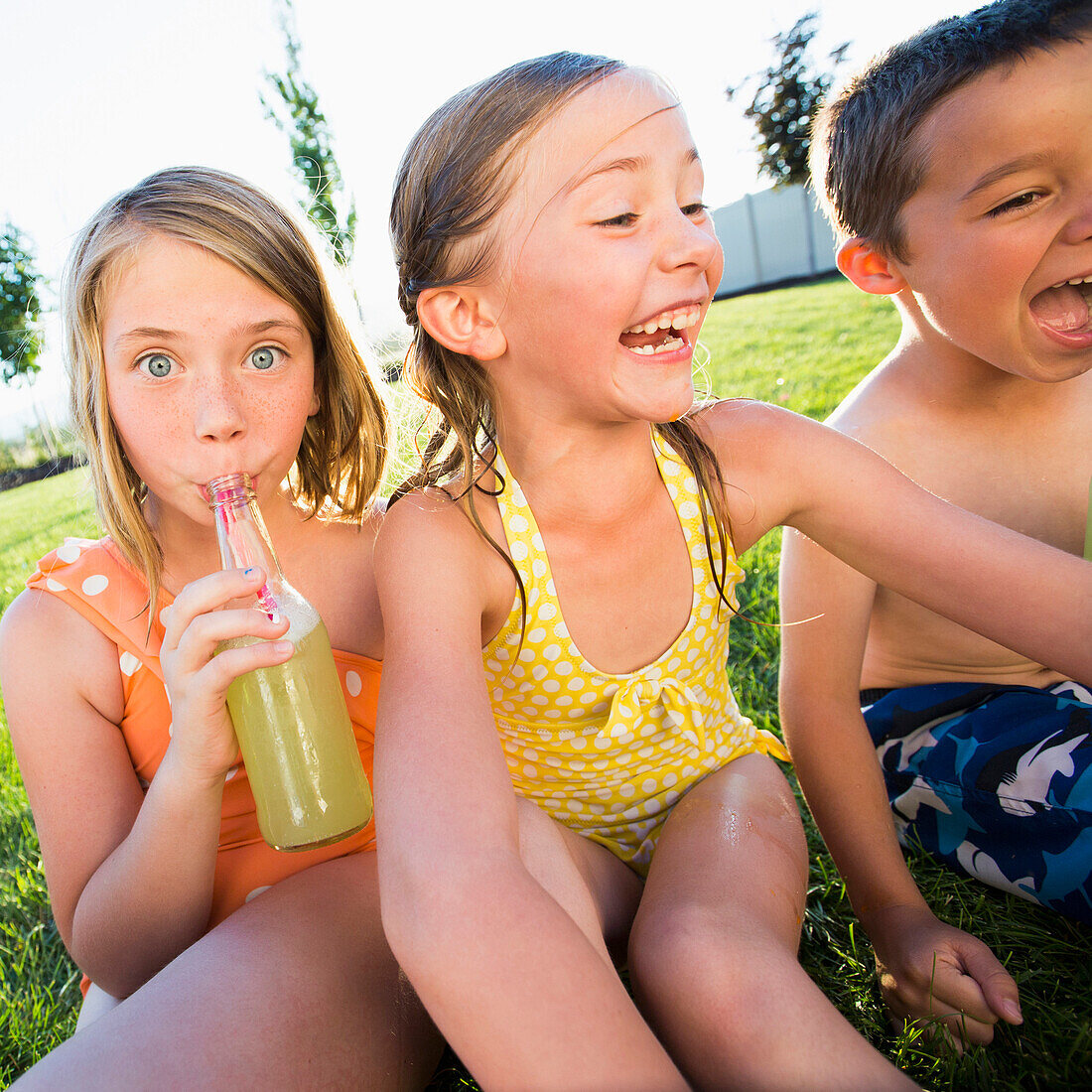 Caucasian children drinking soda in backyard, Lehi, Utah, USA
