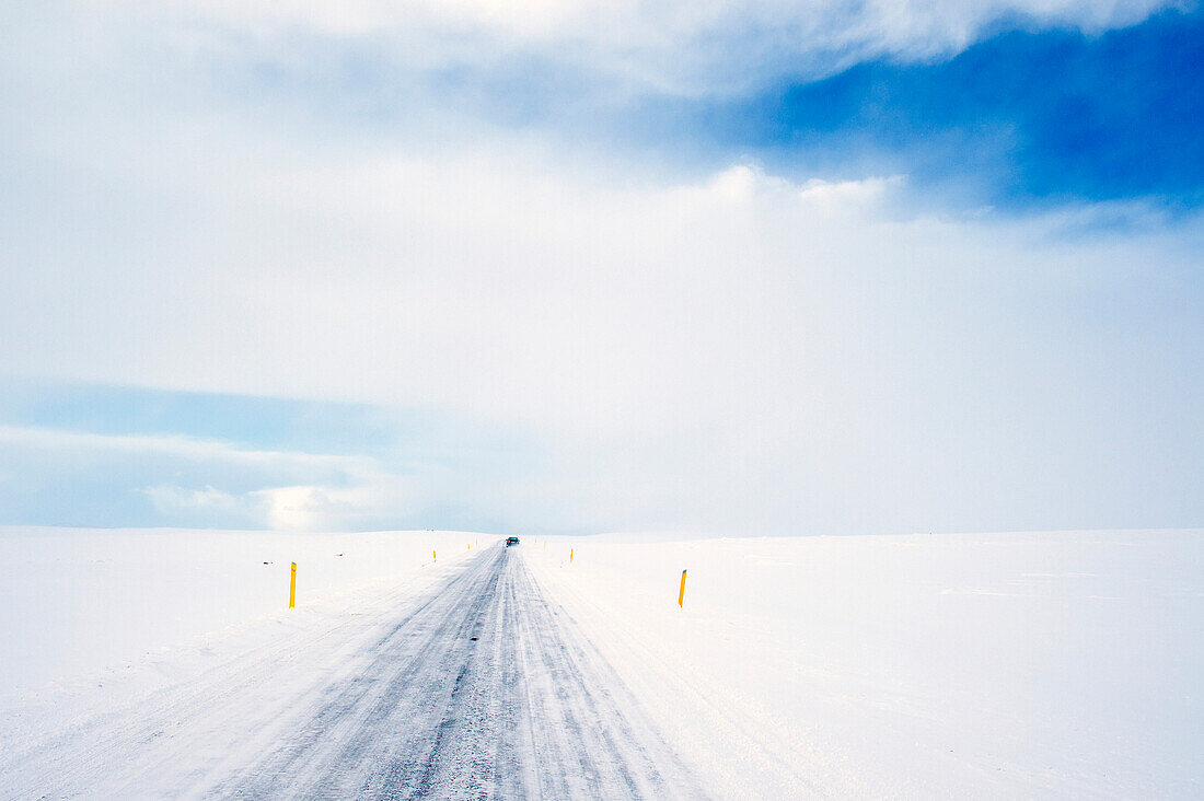 Tire tracks on rural road in snowy landscape, reykjavik, Hofudborgarsvaedi, Iceland