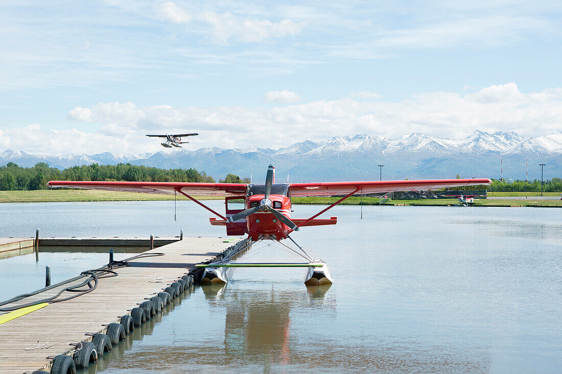 Seaplane docked in rural river, Anchorage, Alaska, USA