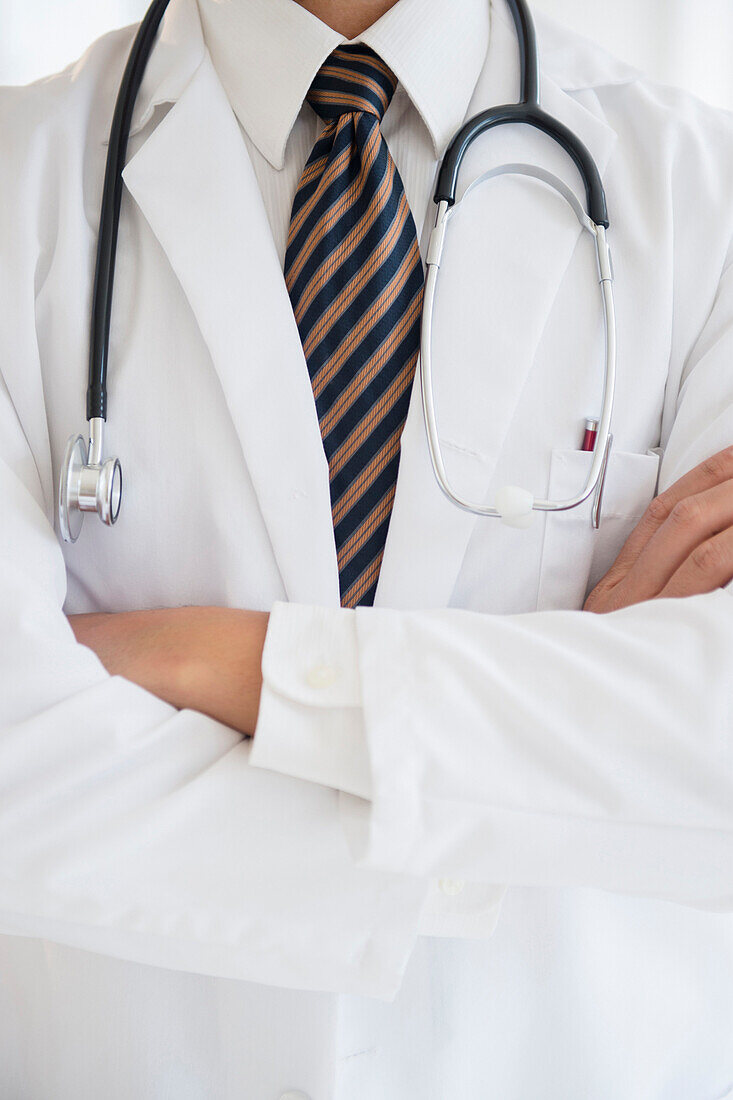 Close up of mixed race doctor with arms crossed, C1