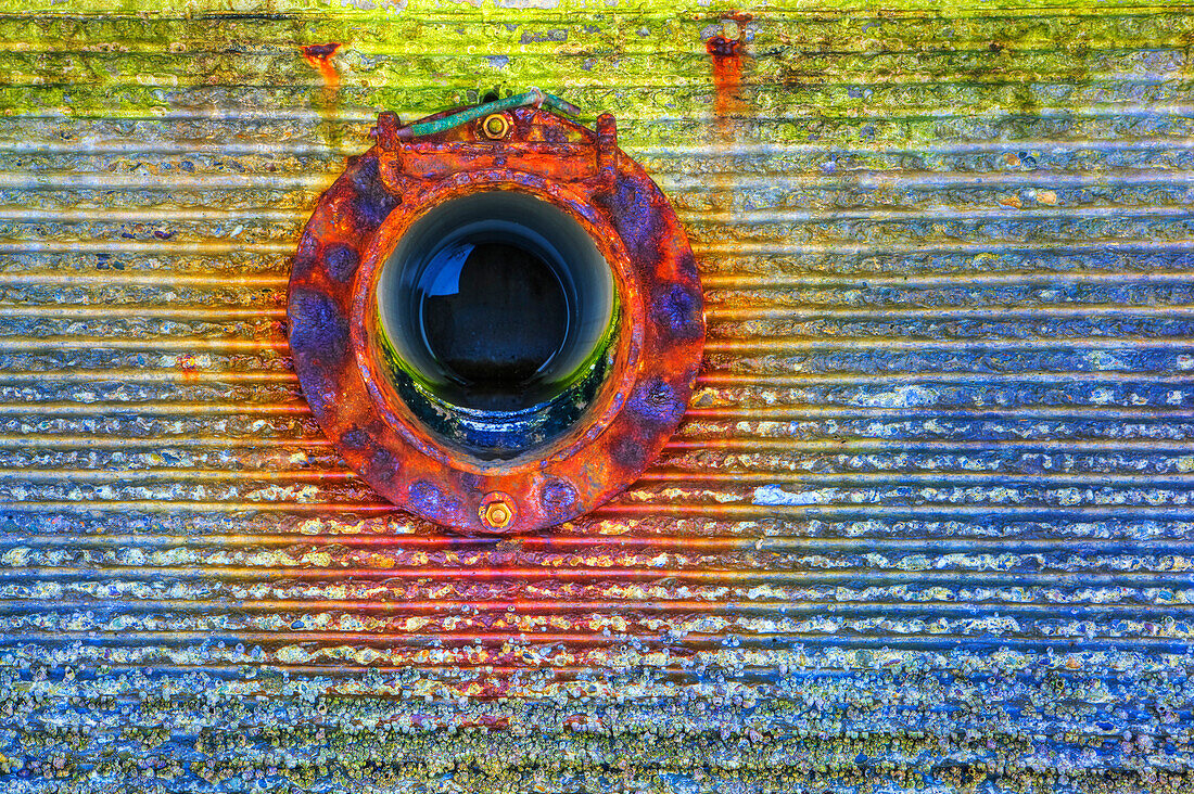Close up of circular window on rusting wall, C1