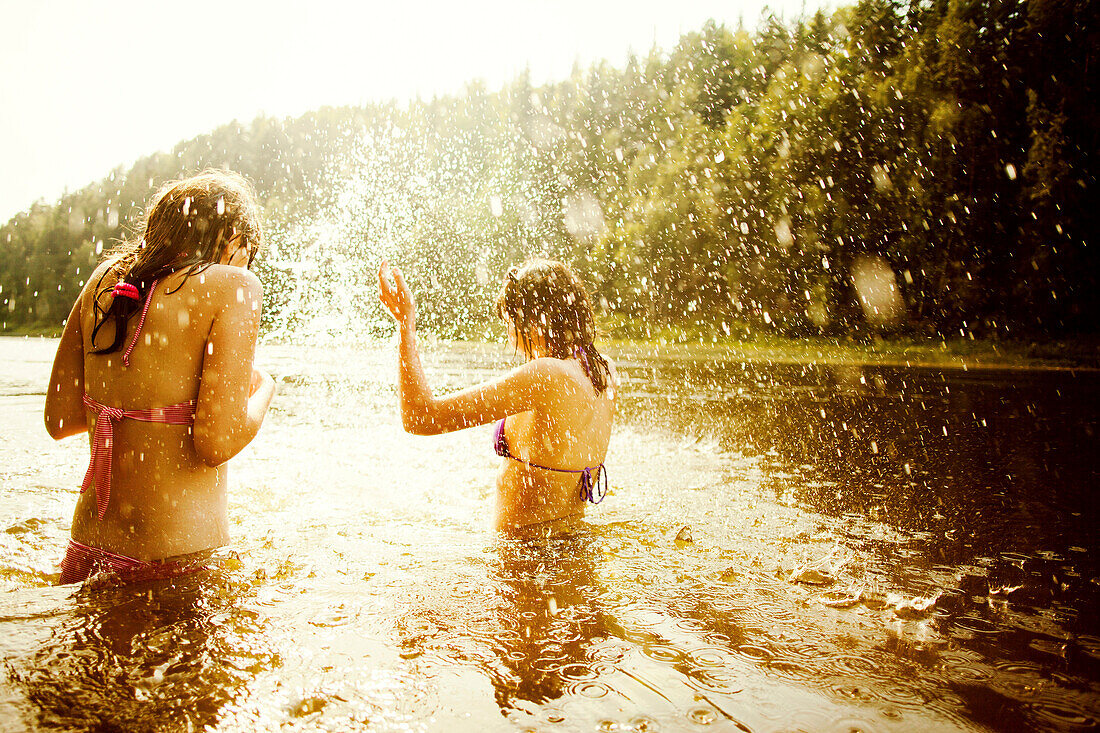 Girls splashing together in lake, Sarsy village, Sverdlovsk region, Russia