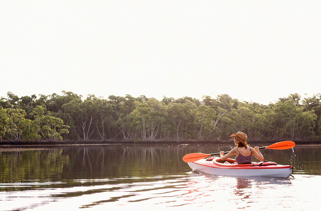 Mixed race woman kayaking in lake, Miami, Florida, United States