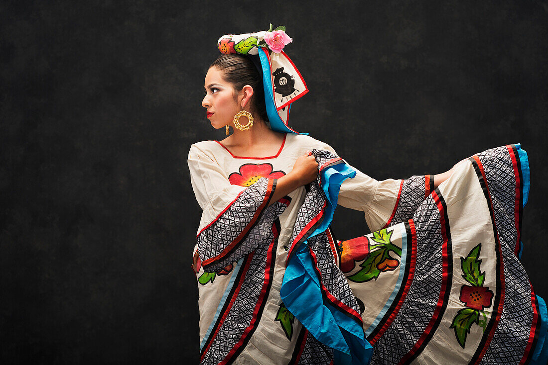 Hispanic teenage girl dancing in Sinaloa Folkloric dress, Petaluma, California, United States
