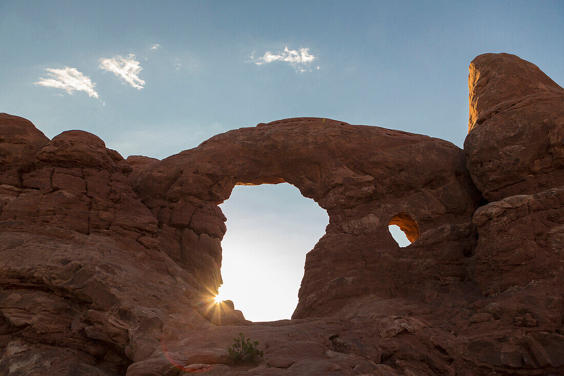 Low angle view of Turret Arch rock formation under blue sky, Arches National Park, Utah, United States, Arches National Park, Utah, USA