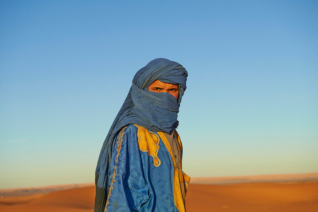 Guide wearing face protection in desert landscape, Sahara Desert, Morocco, Morocco