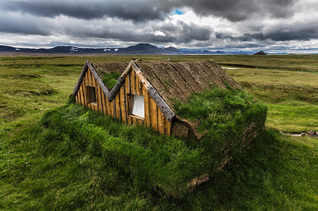 Overgrown sod house in rural landscape, Modrudalur, Iceland, Iceland