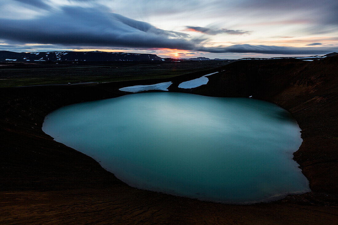 Volcanic crate pool in rock formations under sunset sky, Myvatn, Iceland, Iceland