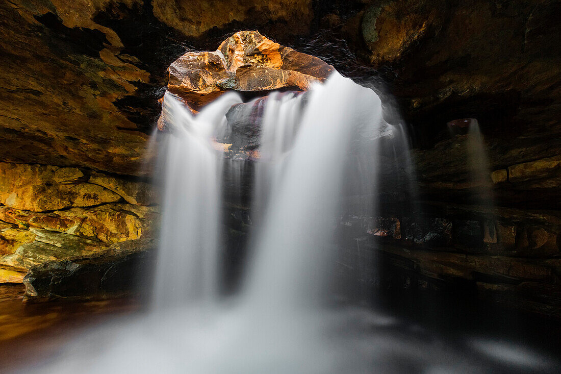 Time lapse view of waterfall flowing in rock cave, Gifberg Holiday Farm, Northern Cape, South Africa