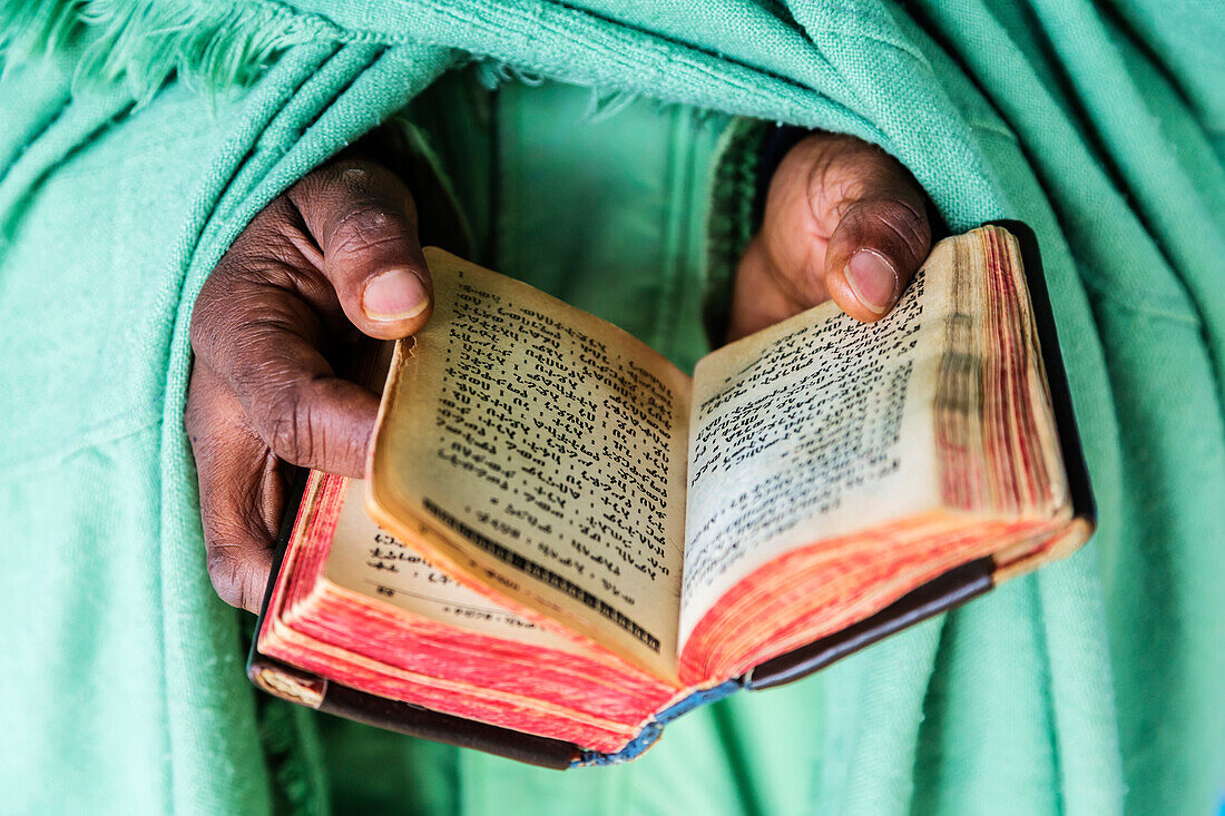 Close up of hands of priest holding Bible, Addis Ababa, Ntoto Hill, Ethiopia