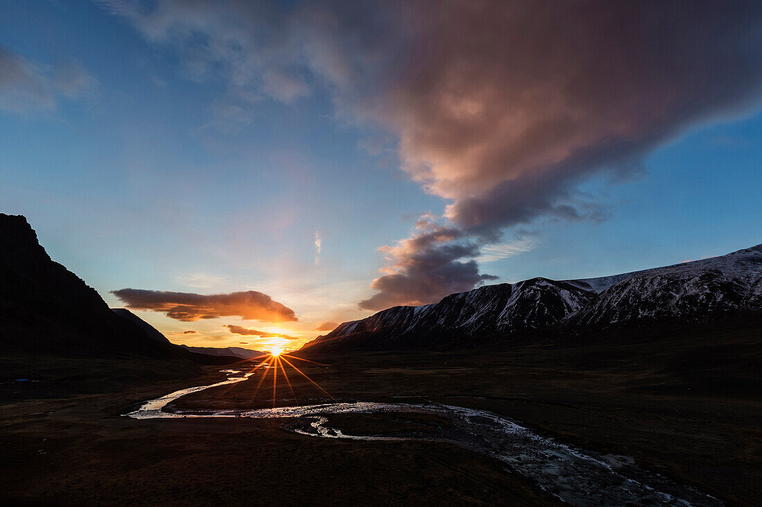 Sunset sky over river and remote mountain landscape, Altai Tavn Bogd National Park, Bayan Ulgii, Mongolia