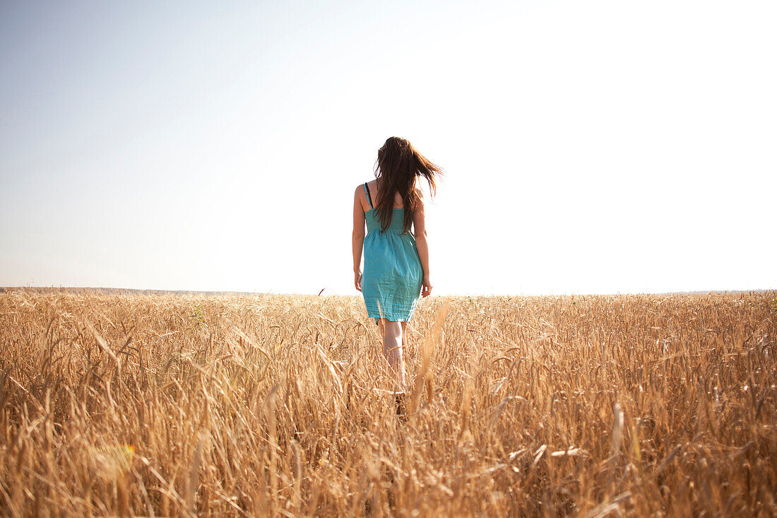 Caucasian woman walking in rural field, Nizhniy Tagil, Sverdlovsk region, Russia