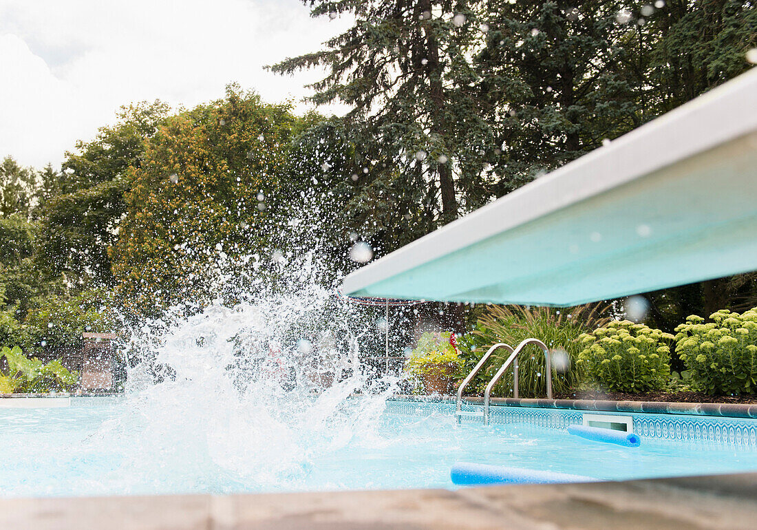 Splashing water near diving board in swimming pool, Huntington Station, New York, USA