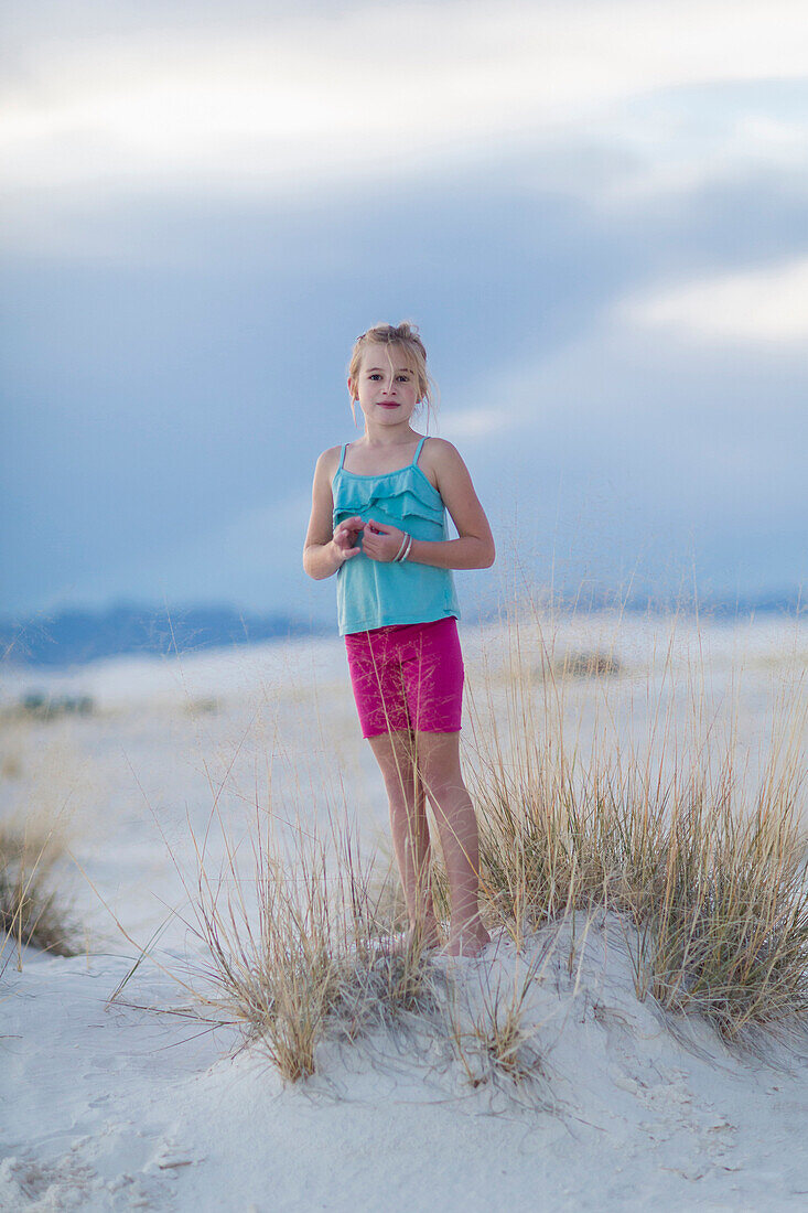 Caucasian girl standing on sand dune, White Sands, New Mexico, USA