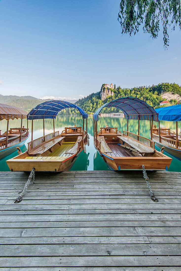 Boats parked on wooden dock on lake, Bled, Upper Carniola, Slovenia