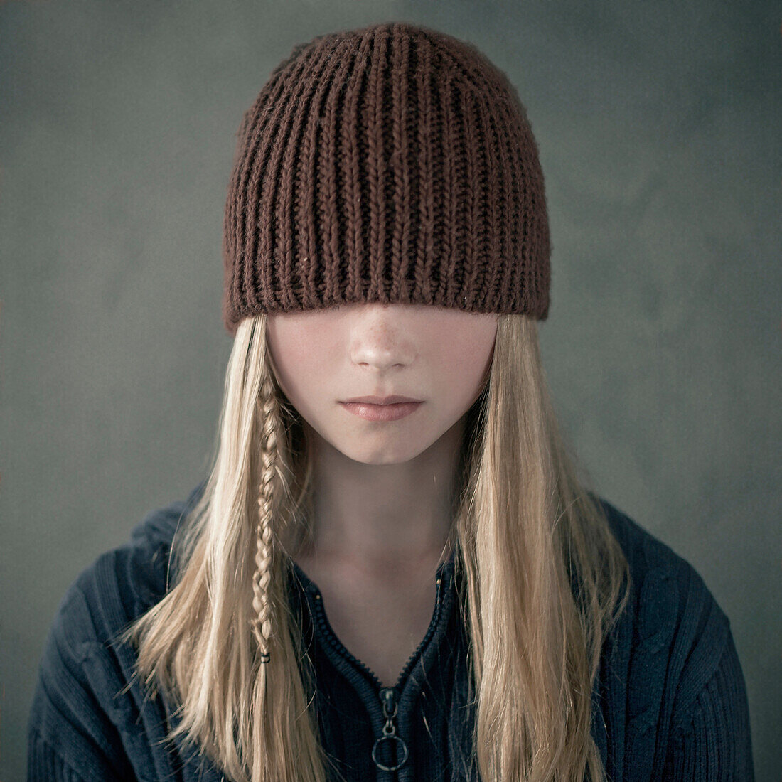 Teenage girl wearing knitted cap over eyes, Nizniy Tagil, Sverdlovsk, Russia