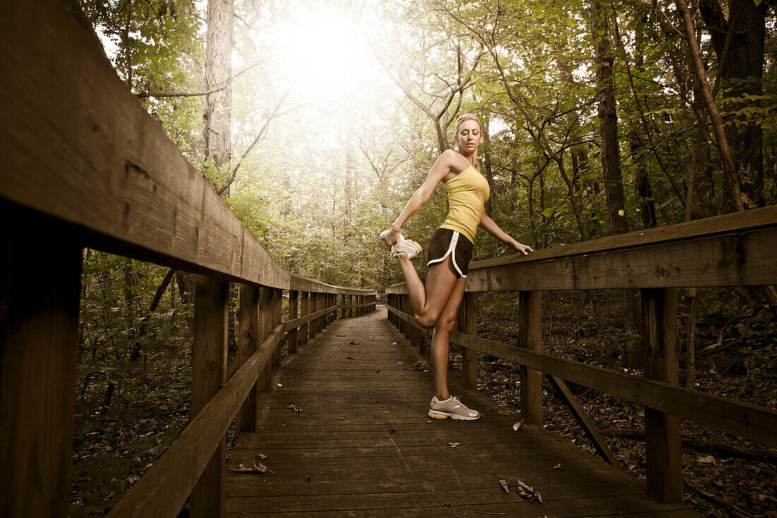 Caucasian woman stretching before exercise, Saint Louis, MO, USA