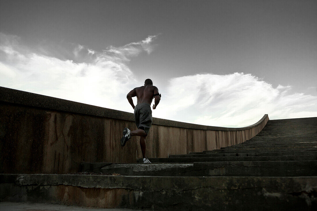 Black man running up stairs, Saint Louis, MO, USA