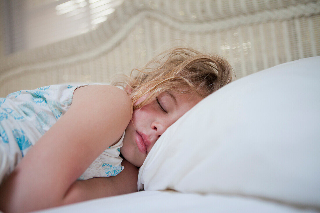 Caucasian girl sleeping in bed, Florida Keys, Florida, USA