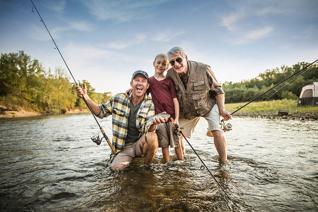 Three generations of Caucasian men fishing in river, Saint Louis, Missouri, USA