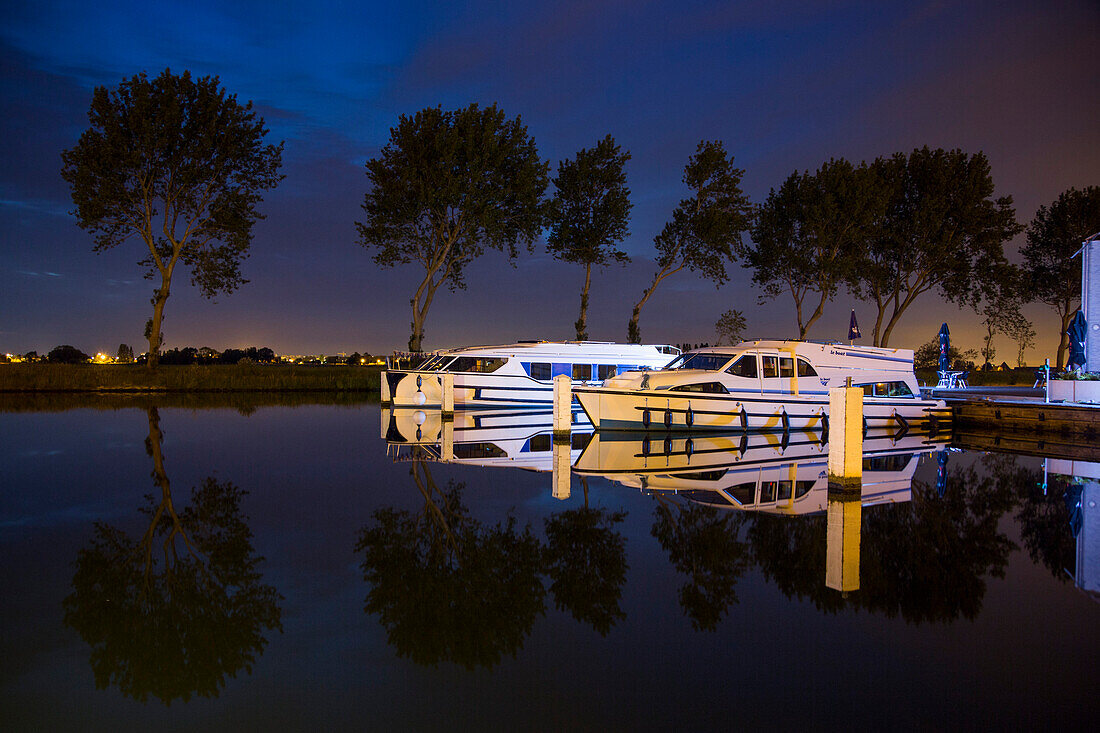Le Boat Royal Mystique and Vision 3 houseboats at Westhoek Marina at night, Nieuwpoort, Flemish Region, Belgium