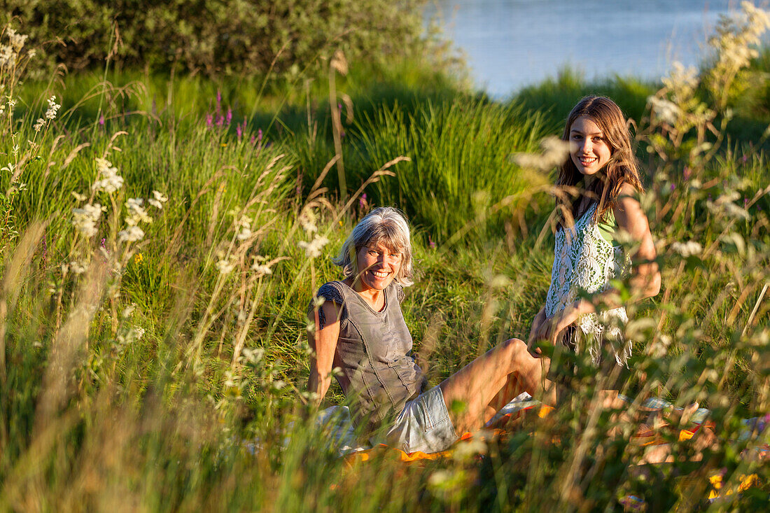 mother and daughter in bloming meadow at lake, Upper Bavaria, Germany, Europe