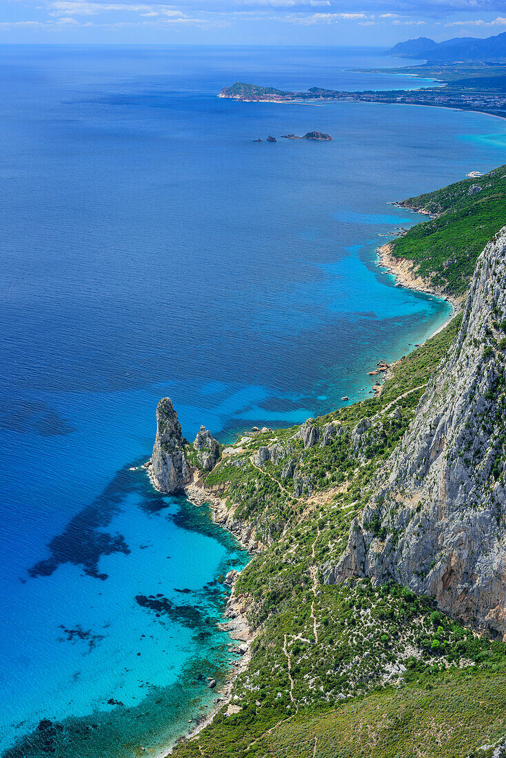 View from Punta Giradili at coast of Golfo di Orosei with rock spire Pedra Longa, Selvaggio Blu, National Park of the Bay of Orosei and Gennargentu, Sardinia, Italy
