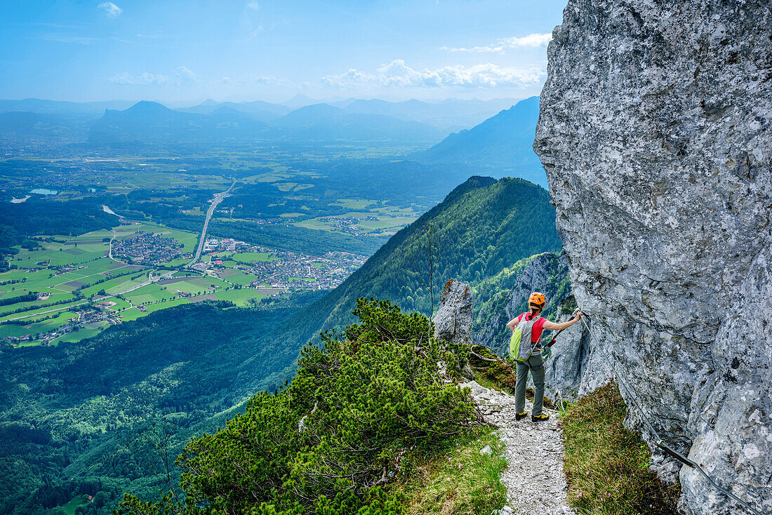 Woman ascending on fixed rope route, fixed rope route Pidinger Klettersteig, Hochstaufen, Chiemgau Alps, Chiemgau, Upper Bavaria, Bavaria, Germany