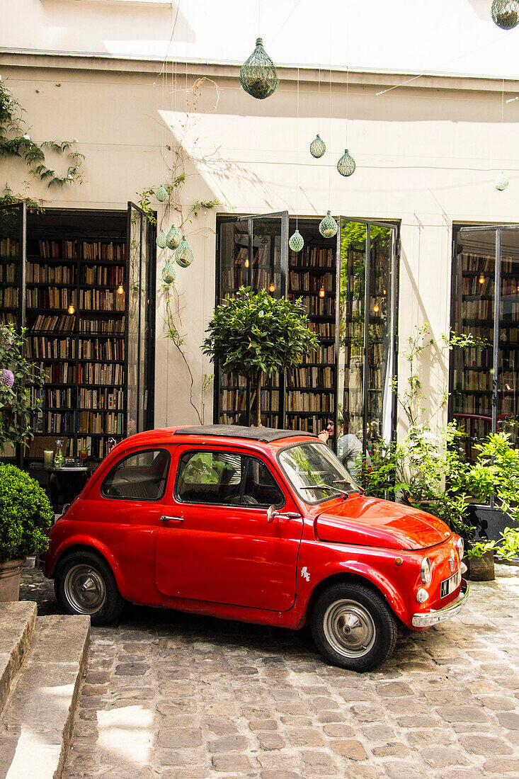 France, Paris, Marais, Merci charity shop, inner courtyard, old red Fiat 500