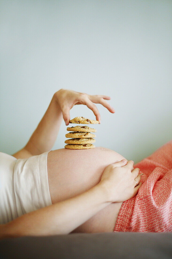 Cookies placed on the belly of a 7 months pregnant woman