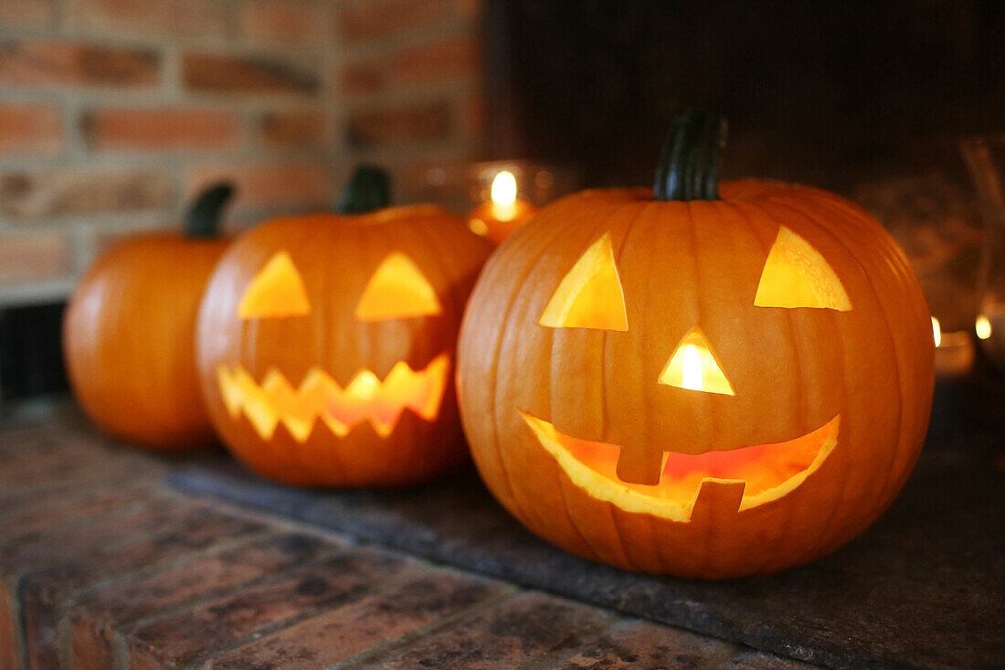 Still life of jack-o-lantern and illuminated Halloween pumpkins