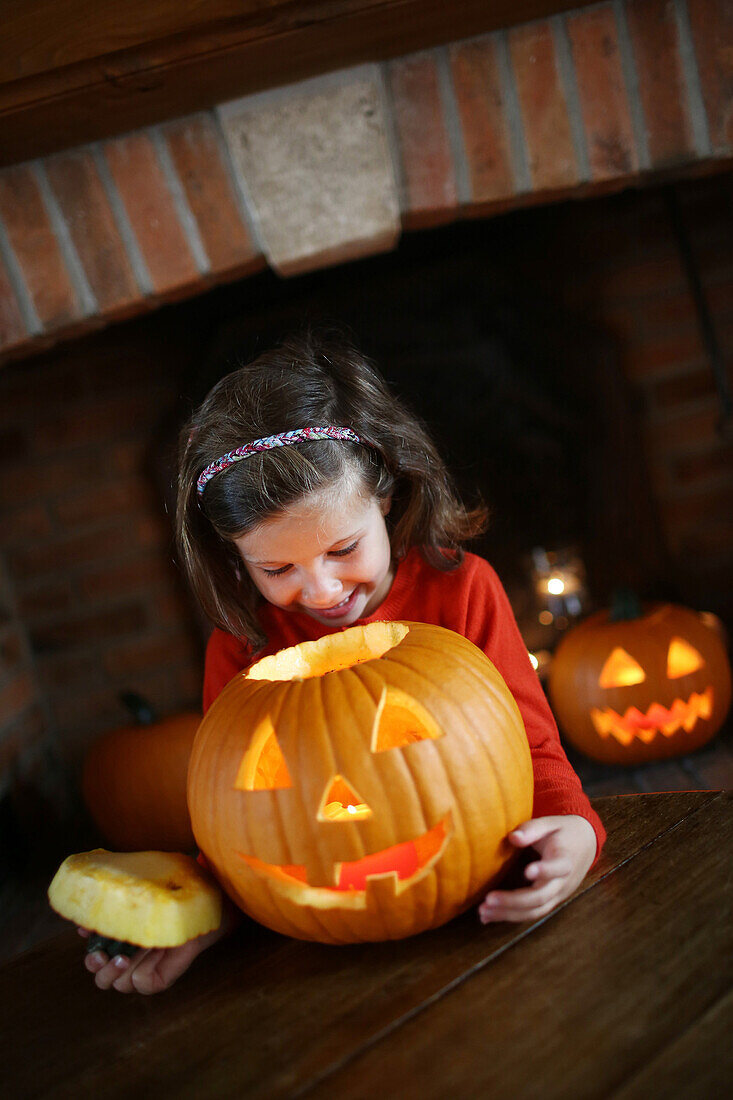 Little girl looking in a Jack-o-lantern