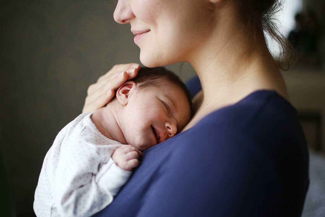 A 10 days baby girl in the arms of her mother