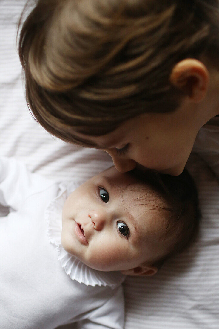 cute baby girl and boy kissing